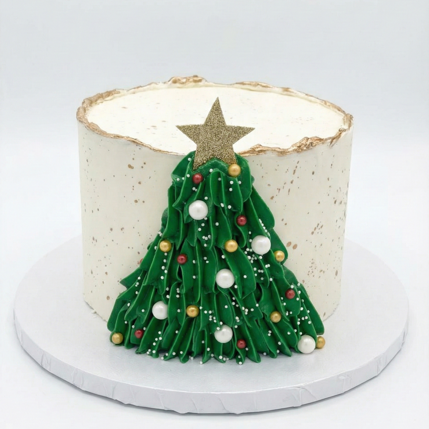 Cake with a Christmas tree and gold accents